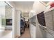Walk-in closet with custom shelving and storage solutions adjacent to main bedroom and fireplace at 3057 S University Cir, Englewood, CO 80113