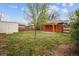 Spacious backyard features a pergola, shed, garden, and tree, offering an ideal setting for relaxation or entertaining at 1456 Wabash St, Denver, CO 80220