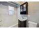 Cozy bathroom featuring a tub, classic vanity, and modern finishes at 1456 Wabash St, Denver, CO 80220