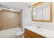 Tiled bathroom with tub, shower, vanity, and ample lighting at 1456 Wabash St, Denver, CO 80220