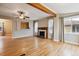 Open-concept living room featuring hardwood floors, fireplace, and beam at 1456 Wabash St, Denver, CO 80220