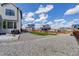 Expansive backyard featuring gravel, grass, a patio, a fence, and views of nearby homes at 1256 Elbridge Dr, Elizabeth, CO 80107