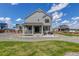 Backyard featuring a covered porch, gravel landscaping, and lawn, plus a wooden fence at 1256 Elbridge Dr, Elizabeth, CO 80107
