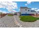 Wide backyard view featuring gravel, grass, homes, and a rustic wooden fence at 1256 Elbridge Dr, Elizabeth, CO 80107