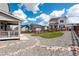 Large backyard with gravel landscaping, grass patches, stone walkway and wooden fence surroundings at 1256 Elbridge Dr, Elizabeth, CO 80107