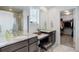 Bathroom with double vanity sinks, granite countertops, walk-in shower, and view to a walk-in closet at 1256 Elbridge Dr, Elizabeth, CO 80107