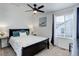 Bright bedroom features a ceiling fan, a boat painting, and a window with white blinds at 1256 Elbridge Dr, Elizabeth, CO 80107