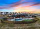 Aerial shot of the community pool and clubhouse during sunset at 1256 Elbridge Dr, Elizabeth, CO 80107