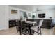 Open-concept dining area flows to living room; features wood table and view to staircase at 1256 Elbridge Dr, Elizabeth, CO 80107