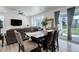 Open-concept dining area with wood table, sliding glass doors, and a view to the backyard at 1256 Elbridge Dr, Elizabeth, CO 80107
