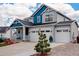 Home exterior featuring a three car garage and partial blue accents at 1256 Elbridge Dr, Elizabeth, CO 80107