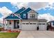 Home exterior showing three-car garage, and well-manicured lawn at 1256 Elbridge Dr, Elizabeth, CO 80107