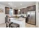 Modern kitchen boasts stainless steel appliances, a granite island, and dark cabinetry at 1256 Elbridge Dr, Elizabeth, CO 80107