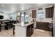 Modern kitchen features a granite island, stainless steel appliances, and hardwood floors at 1256 Elbridge Dr, Elizabeth, CO 80107