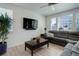 Cozy living room with neutral colors, large sofa, wooden coffee table, and a large window at 1256 Elbridge Dr, Elizabeth, CO 80107