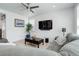 Bright living room with modern ceiling fan, stylish decor, and comfortable gray couch at 1256 Elbridge Dr, Elizabeth, CO 80107