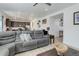 Open-concept living room flows into a modern kitchen featuring a comfortable, reclining sofa at 1256 Elbridge Dr, Elizabeth, CO 80107