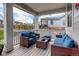 Relaxing covered patio with comfortable wicker furniture and blue cushions, perfect for outdoor enjoyment at 1256 Elbridge Dr, Elizabeth, CO 80107