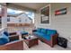 Inviting covered patio with stylish wicker furniture and colorful Colorado-themed wall art at 1256 Elbridge Dr, Elizabeth, CO 80107