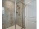 Walk-in shower featuring neutral tile and a built-in shower caddy at 1256 Elbridge Dr, Elizabeth, CO 80107