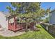 Charming home with a spacious wooden deck, grassy yard, and mature trees at 11014 Callaway Rd, Parker, CO 80138