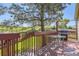 Outdoor wooden deck with a grill, dining table, and views of the green backyard at 11014 Callaway Rd, Parker, CO 80138