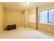 Clean basement with a storage chest, whiteboard, and a window for natural light at 11014 Callaway Rd, Parker, CO 80138