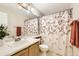 Bright bathroom with a floral shower curtain, a large mirror, and a classic vanity at 11014 Callaway Rd, Parker, CO 80138