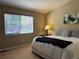 Bedroom features include a plush bed with textured bedding and a window with wood-tone blinds at 11014 Callaway Rd, Parker, CO 80138