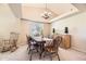 Elegant dining room with a tray ceiling, chandelier, and wooden furniture, creating a warm ambiance at 11014 Callaway Rd, Parker, CO 80138