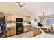 Well-lit kitchen featuring wooden cabinets, modern appliances, and a functional layout for cooking at 11014 Callaway Rd, Parker, CO 80138