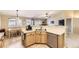 Functional kitchen with stainless steel appliances, light wood cabinets, and an adjacent dining area at 11014 Callaway Rd, Parker, CO 80138