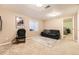 Cozy living room features plush seating, soft carpet, and natural light from a window at 11014 Callaway Rd, Parker, CO 80138