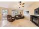 Comfortable living room with leather furniture, a ceiling fan, and access to an outdoor deck area at 11014 Callaway Rd, Parker, CO 80138