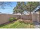 A verdant lawn graces the backyard, complemented by a classic wood fence at 2065 Depew St, Edgewater, CO 80214