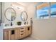Modern bathroom with double vanity, contemporary mirrors, and ample natural light at 2065 Depew St, Edgewater, CO 80214