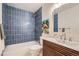 Bathroom featuring blue tiled shower and unique vanity with a vessel sink at 2065 Depew St, Edgewater, CO 80214