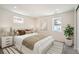Cozy bedroom featuring neutral tones, a comfortable bed, and natural light from the windows at 2065 Depew St, Edgewater, CO 80214
