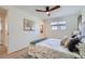 Cozy bedroom showcasing neutral tones, a comfortable bed, and ample natural light from the window at 2065 Depew St, Edgewater, CO 80214
