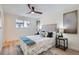 Bright bedroom with a ceiling fan, plush bed, stylish decor, and large window for natural light at 2065 Depew St, Edgewater, CO 80214