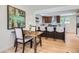 Elegant dining room area with hardwood floors, stylish furniture, and views of the open kitchen and front entrance at 2065 Depew St, Edgewater, CO 80214