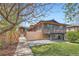 Beautiful home exterior featuring a modern deck, a well manicured lawn, and stylish accents under a clear blue sky at 2065 Depew St, Edgewater, CO 80214