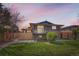 Charming two-story home with modern architecture, a yard, and a fenced walkway at 2065 Depew St, Edgewater, CO 80214