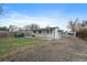 This backyard features a covered patio and a mix of gravel and grass at 7460 Krameria Dr, Commerce City, CO 80022