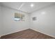 This basic bedroom has a window and wood-look flooring, ready for personalization at 7460 Krameria Dr, Commerce City, CO 80022