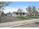 The property includes a fenced yard, shed, and a covered porch for curb appeal at 7460 Krameria Dr, Commerce City, CO 80022
