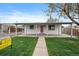 Charming single-story home with a covered porch and a well-maintained front yard at 7460 Krameria Dr, Commerce City, CO 80022