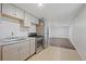 Kitchen with stainless steel appliances seamlessly connecting to the living space at 7460 Krameria Dr, Commerce City, CO 80022