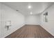 Bright living room featuring modern flooring, wainscotting and a large window at 7460 Krameria Dr, Commerce City, CO 80022