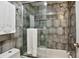 Bathroom featuring large tiled shower with glass door, neutral tones, and a rainfall shower head at 937 Clarkson St # 101, Denver, CO 80218